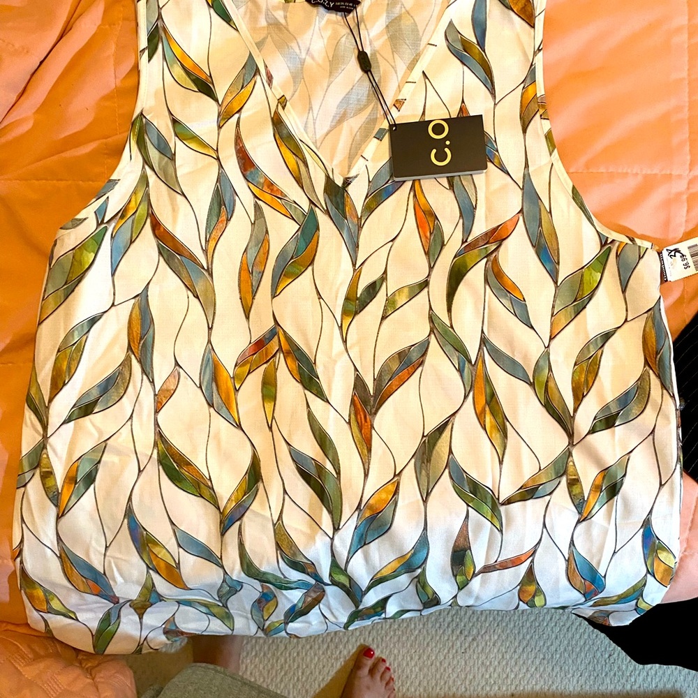 C.O.Z.Y tee with a green and gold leaf pattern atop a white background.